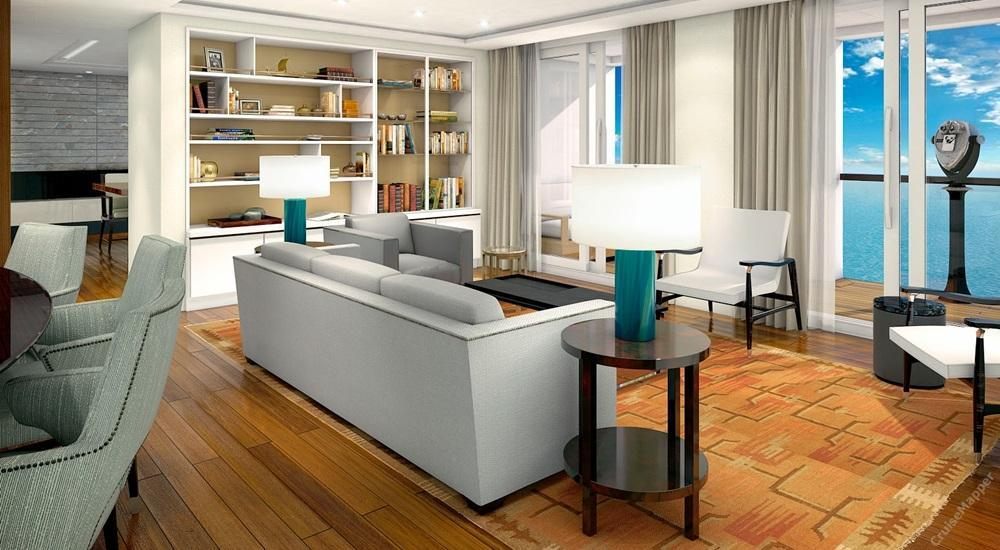 Bright suite living room with sofas, bookshelves and an ocean view